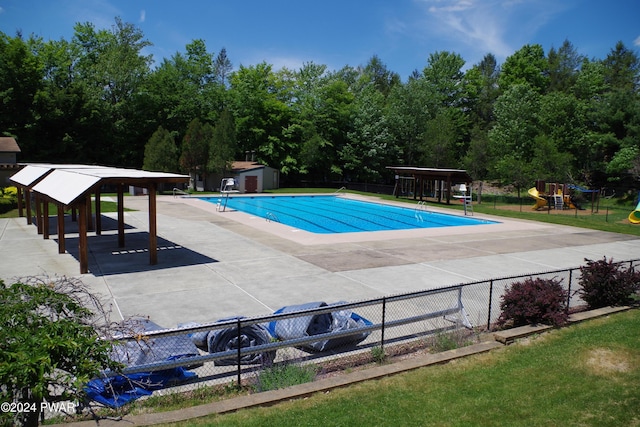 view of swimming pool featuring a storage unit and a patio area