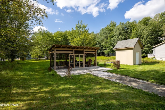 view of yard with a shed and a patio area