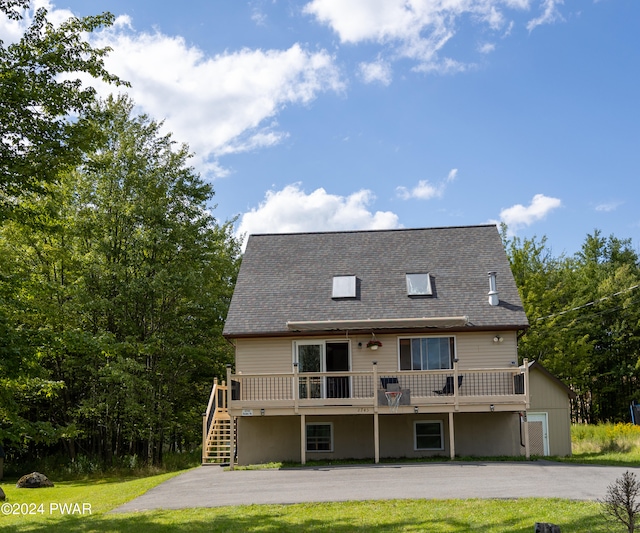 rear view of house featuring a deck