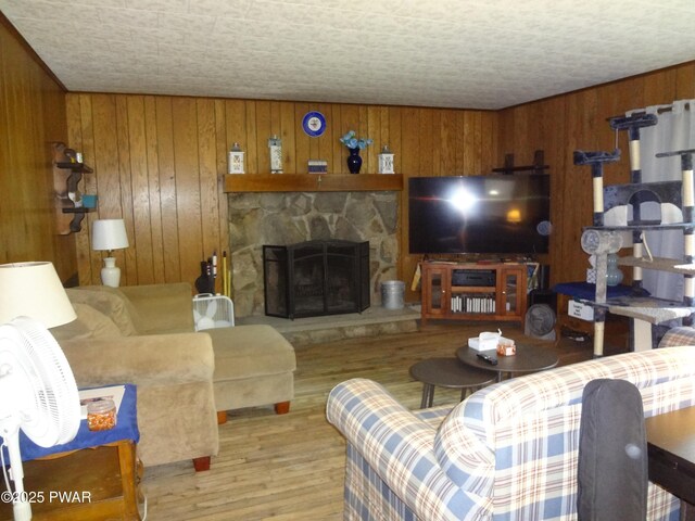 115 Eastwood Dr, Greentown, PA 18426 - living area featuring wood finished floors, wood walls, and a fireplace