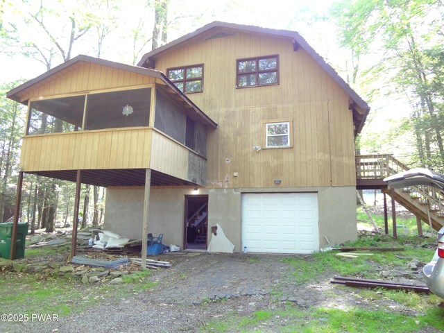 115 Eastwood Dr, Greentown, PA 18426 - rear view of property with a sunroom, a garage, stairs, and a wooden deck