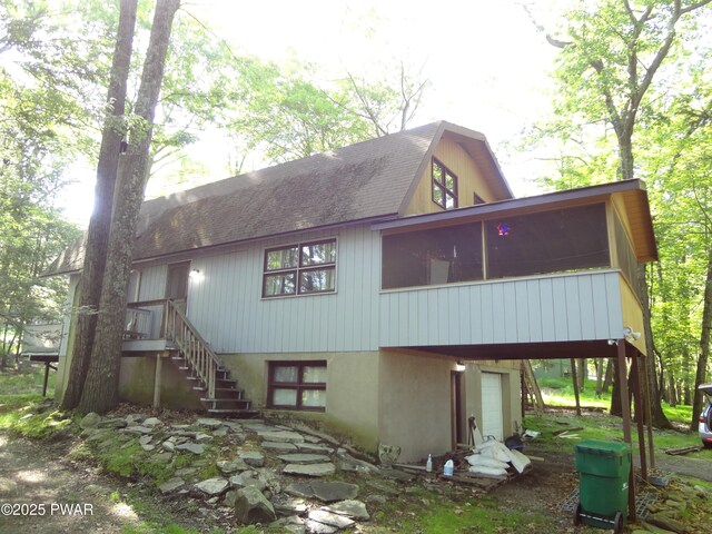 115 Eastwood Dr, Greentown, PA 18426 - back of house featuring a sunroom, stairway, and a shingled roof