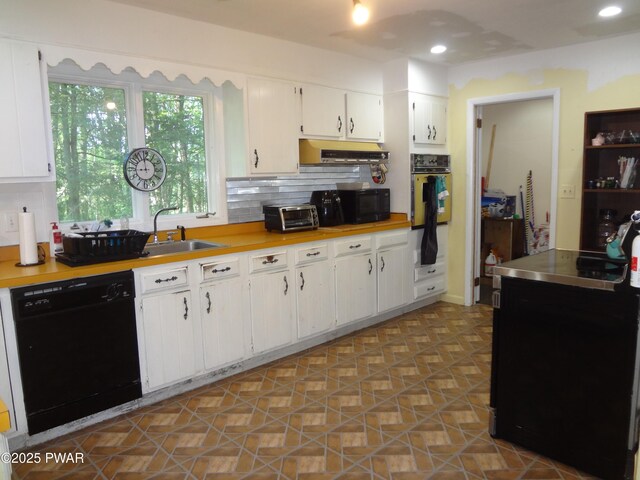 115 Eastwood Dr, Greentown, PA 18426 - kitchen with black appliances, light countertops, white cabinetry, backsplash, and under cabinet range hood