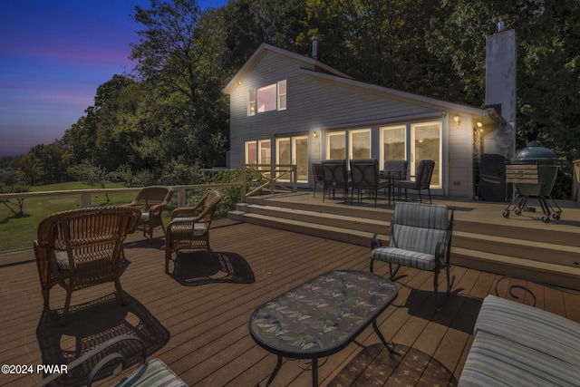 deck at dusk with a grill