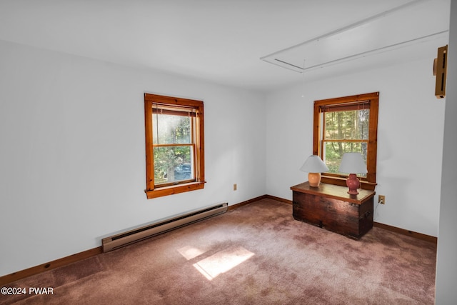 empty room featuring carpet, plenty of natural light, and baseboard heating