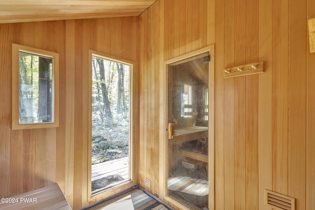 entryway with wood walls