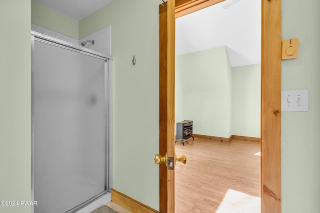 bathroom featuring wood-type flooring and walk in shower