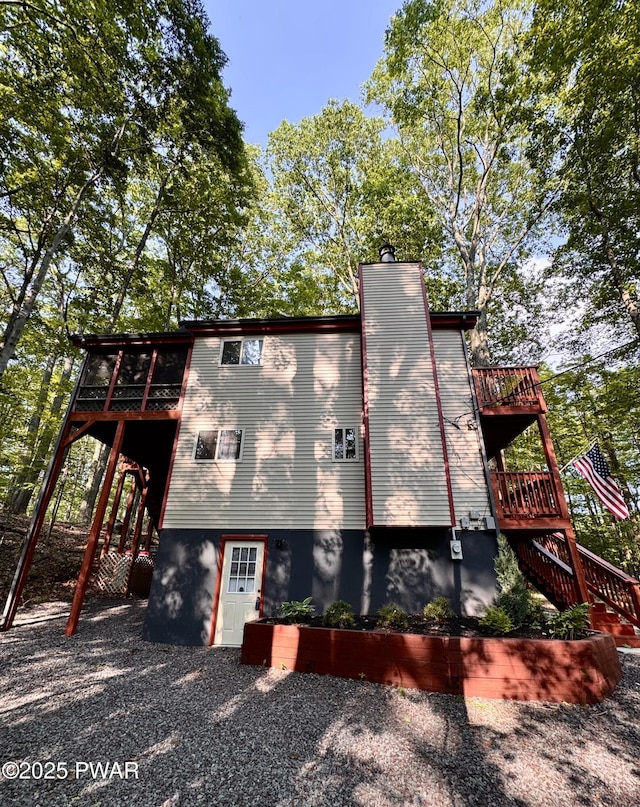 13 Huron Ct, Lake Ariel, PA 18436 - view of side of property with stairs, a deck, and a chimney