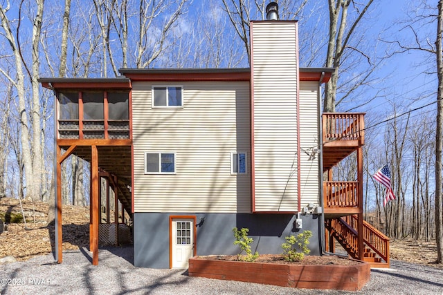 13 Huron Ct, Lake Ariel, PA 18436 - view of side of property with stairs, a sunroom, a wooden deck, and a chimney
