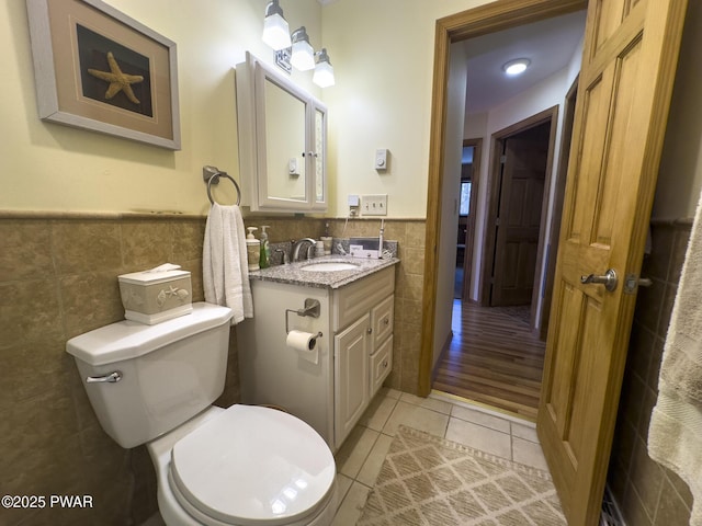 13 Huron Ct, Lake Ariel, PA 18436 - bathroom featuring tile walls, tile patterned floors, wainscoting, and vanity