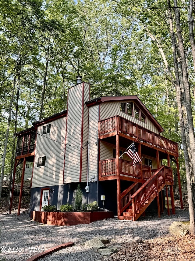 13 Huron Ct, Lake Ariel, PA 18436 - view of front of home featuring a wooden deck, a chimney, and stairs
