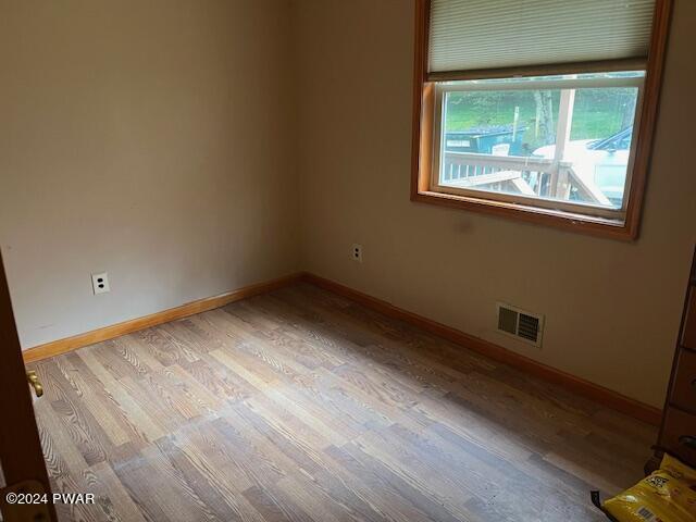 unfurnished room with light hardwood / wood-style floors