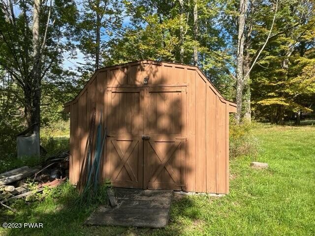 view of outbuilding featuring a yard