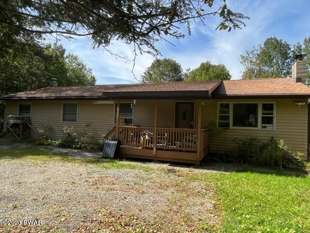 rear view of property with a yard