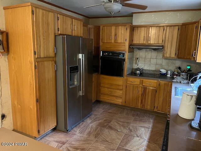 kitchen featuring backsplash, ceiling fan, crown molding, sink, and black appliances