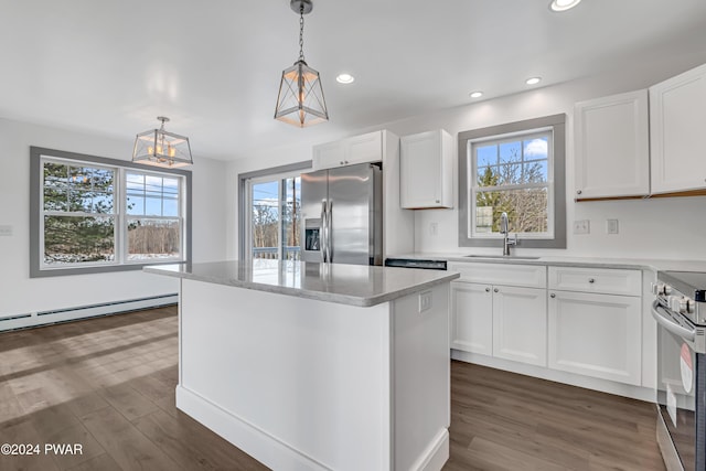 kitchen featuring pendant lighting, sink, white cabinets, and stainless steel appliances