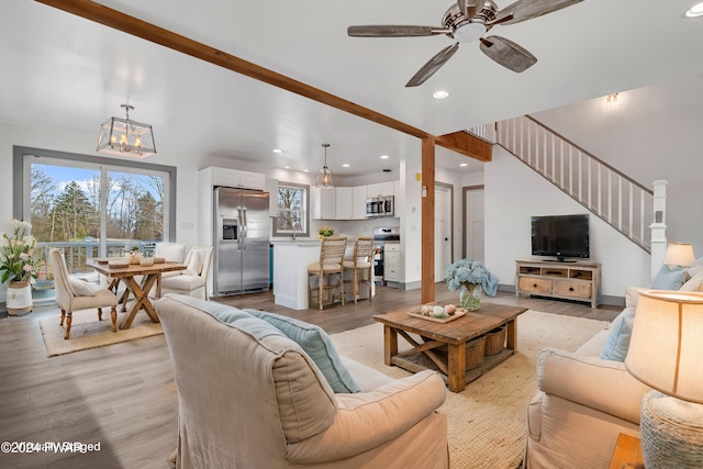 living room featuring light hardwood / wood-style floors and ceiling fan