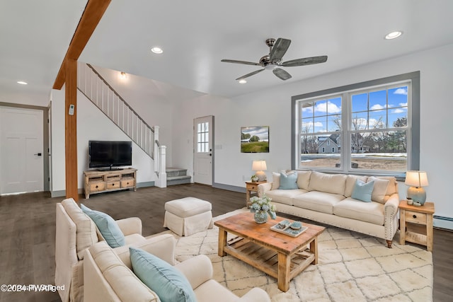 living room featuring light wood-type flooring, baseboard heating, and ceiling fan