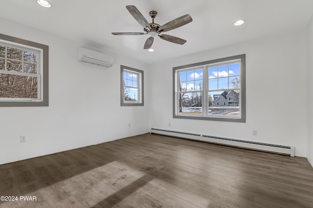 spare room with a wall unit AC, ceiling fan, hardwood / wood-style floors, and a baseboard radiator