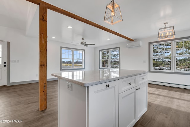 kitchen featuring pendant lighting, white cabinets, baseboard heating, a wall mounted AC, and a kitchen island