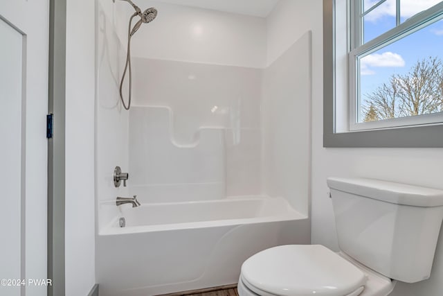 bathroom featuring bathtub / shower combination and toilet