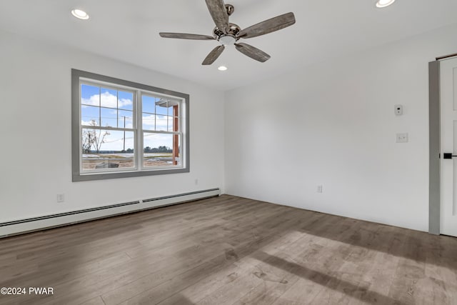 unfurnished room featuring ceiling fan, light hardwood / wood-style floors, and a baseboard heating unit