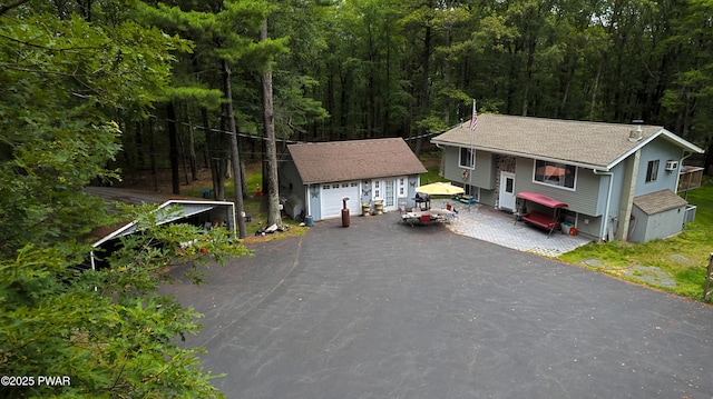 127 E Mulberry Dr, Milford, PA 18337 - view of front of property with an outdoor structure, a forest view, and a detached garage