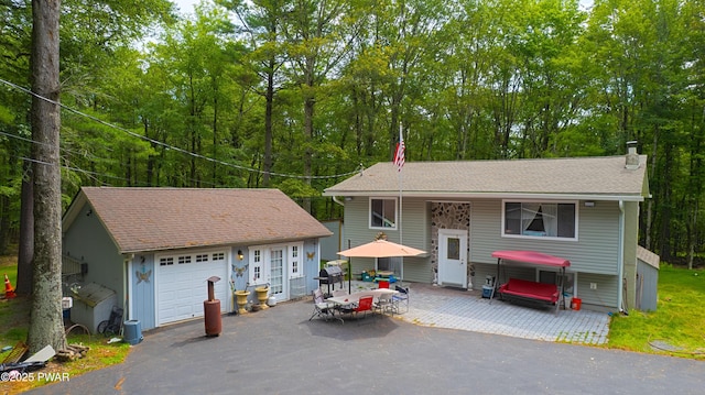 127 E Mulberry Dr, Milford, PA 18337 - view of front of home featuring an outdoor structure, a chimney, and a detached garage