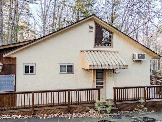 24 Lakeside Dr, Lakeville, PA 18438 - rear view of property with a wooden deck and stucco siding