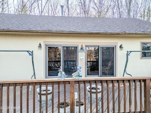 24 Lakeside Dr, Lakeville, PA 18438 - view of exterior entry with a deck, a shingled roof, and stucco siding