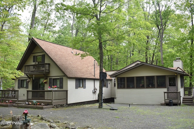 121 Mountain View Dr, Lords Valley, PA 18428 - view of front of property featuring a balcony, a chimney, a wooden deck, and a shingled roof