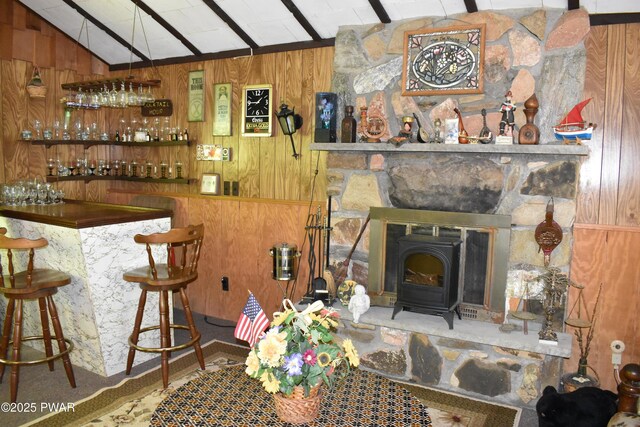 121 Mountain View Dr, Lords Valley, PA 18428 - living room with wood walls, a dry bar, and a wood stove