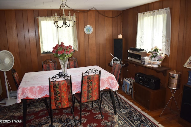 121 Mountain View Dr, Lords Valley, PA 18428 - dining space featuring wooden walls, wood finished floors, and a chandelier
