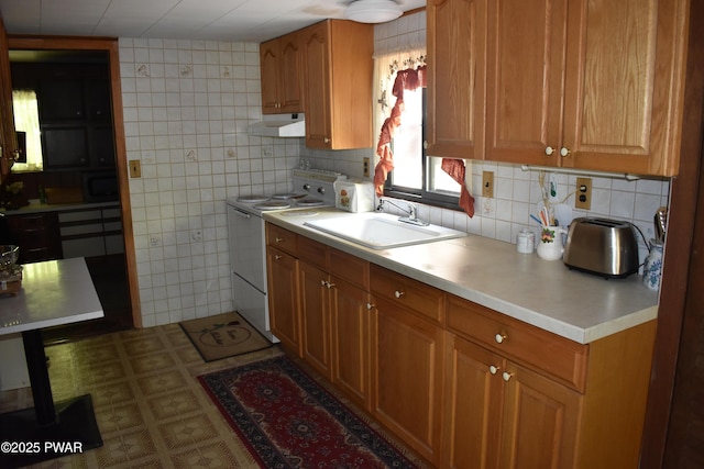 121 Mountain View Dr, Lords Valley, PA 18428 - kitchen featuring white range with electric stovetop, a sink, under cabinet range hood, light countertops, and brown cabinetry