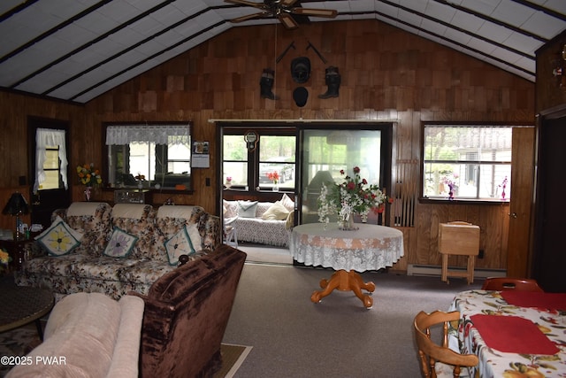 121 Mountain View Dr, Lords Valley, PA 18428 - living room with lofted ceiling, wood walls, plenty of natural light, a ceiling fan, and baseboard heating