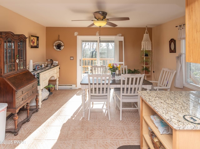 dining space featuring baseboard heating and ceiling fan