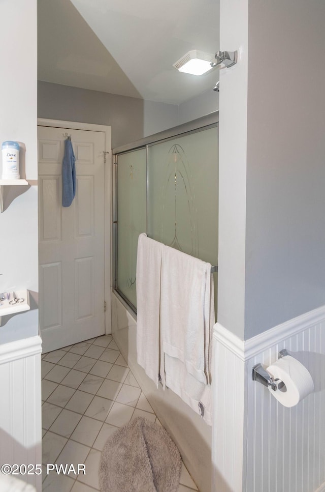 bathroom with enclosed tub / shower combo, tile patterned floors, and vanity