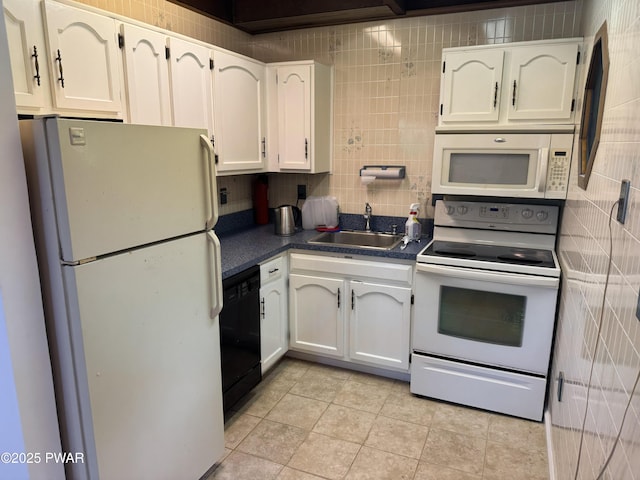 219 Woodpecker Ct, Bushkill, PA 18324 - kitchen featuring white appliances, dark countertops, white cabinetry, tasteful backsplash, and light tile patterned flooring
