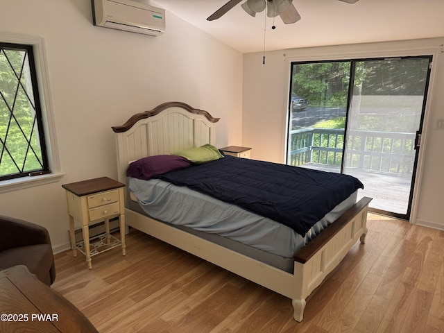 219 Woodpecker Ct, Bushkill, PA 18324 - bedroom with a wall mounted air conditioner, a baseboard radiator, access to exterior, and multiple windows
