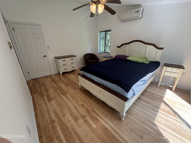 219 Woodpecker Ct, Bushkill, PA 18324 - bedroom featuring a wall unit AC, light wood-style floors, ceiling fan, and lofted ceiling