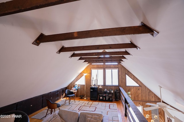 interior space featuring wood walls, lofted ceiling with beams, and wood finished floors