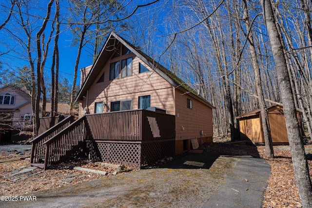 exterior space with driveway and a deck