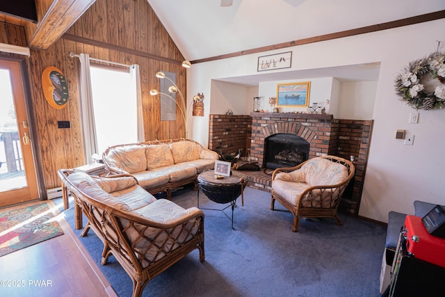 living room with wood walls, a brick fireplace, and a healthy amount of sunlight