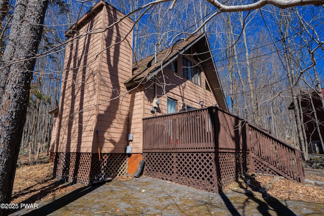 rear view of house featuring a wooden deck