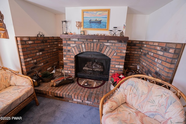 interior space featuring a brick fireplace and carpet