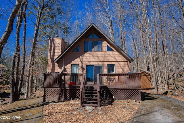 view of front of property featuring a wooden deck and a chimney