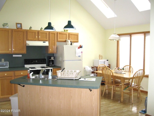 kitchen with decorative backsplash, vaulted ceiling with skylight, white appliances, hardwood / wood-style flooring, and hanging light fixtures