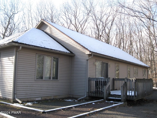 view of property exterior featuring a deck