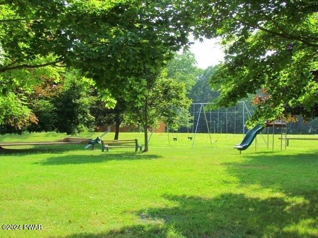 view of community with a playground and a lawn