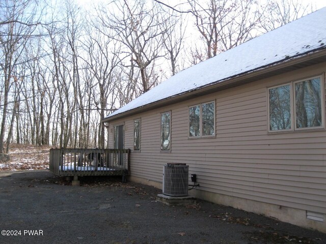 view of side of home featuring central AC unit and a deck